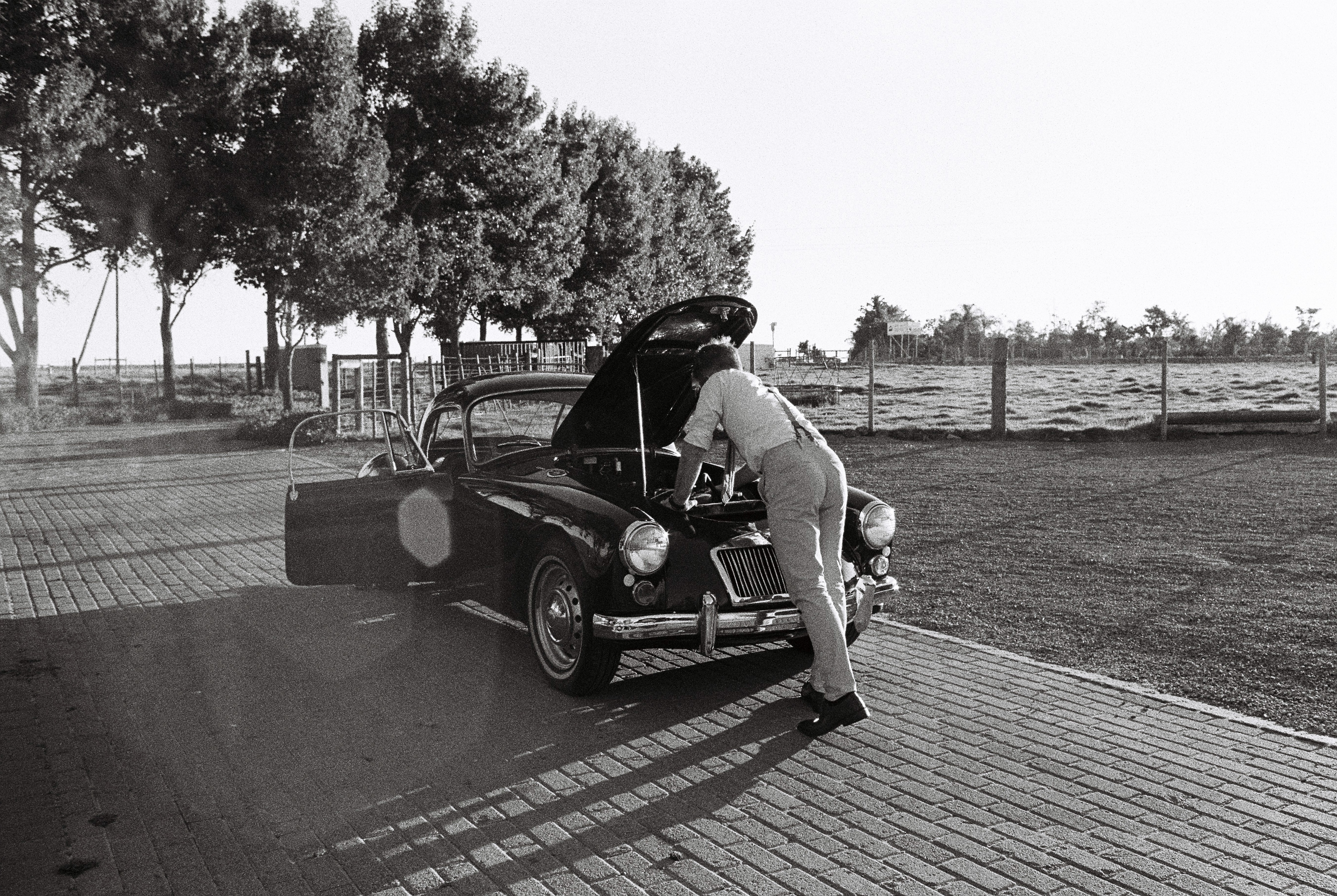 person with vintage car
