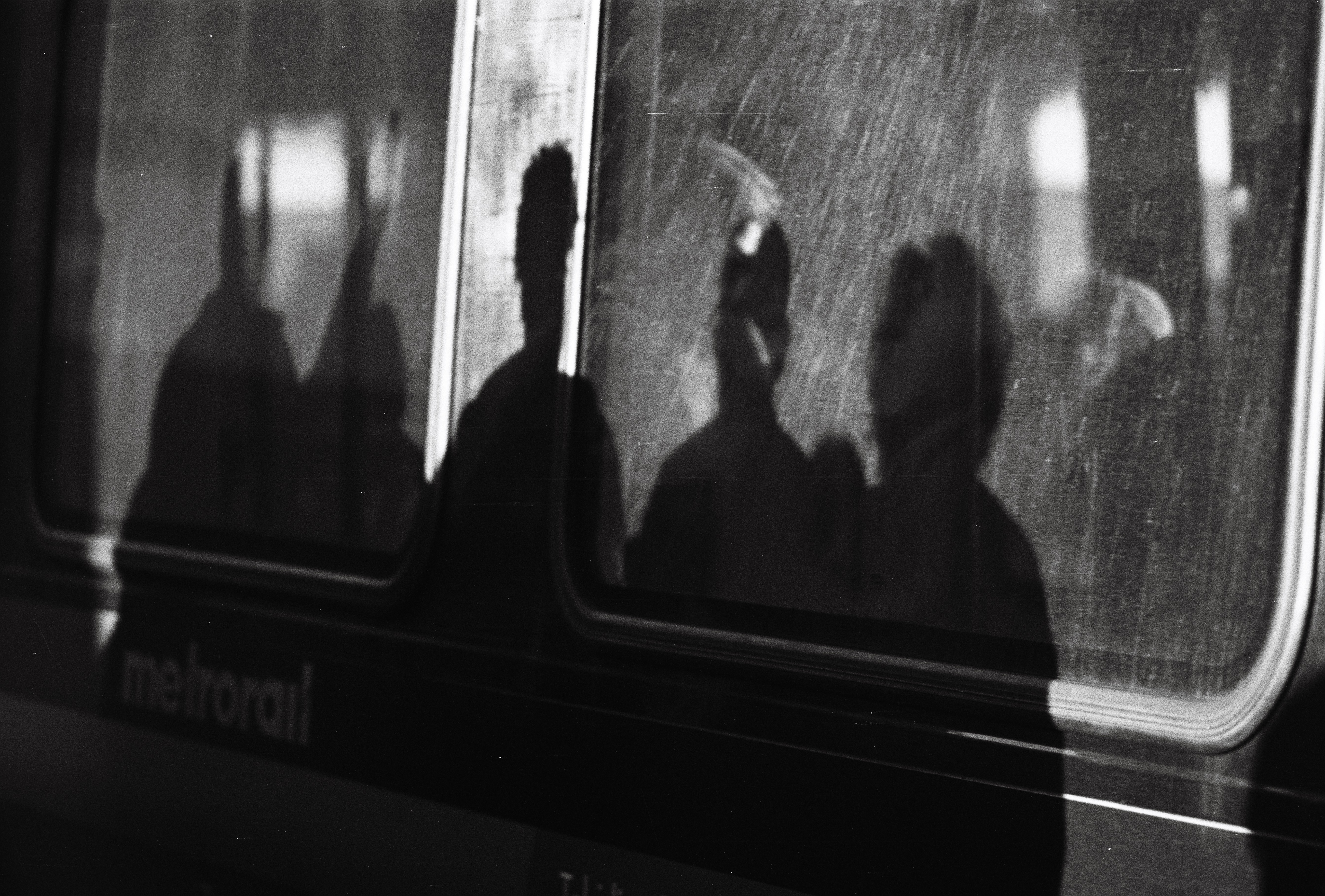 people and shadows outside train